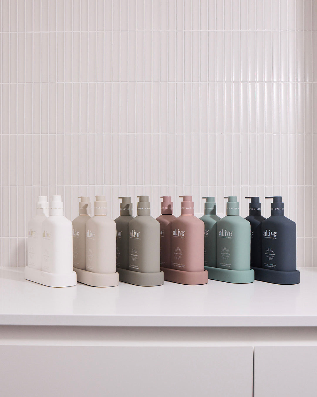 A collection of Al.ive Body wash and lotion duos in various natural colors, available as a luxurious addition to our custom gift hampers.